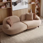 Tolia Sofa modern light beige two-module sofa featuring soft organic contours and plush seating arranged on a round rug.