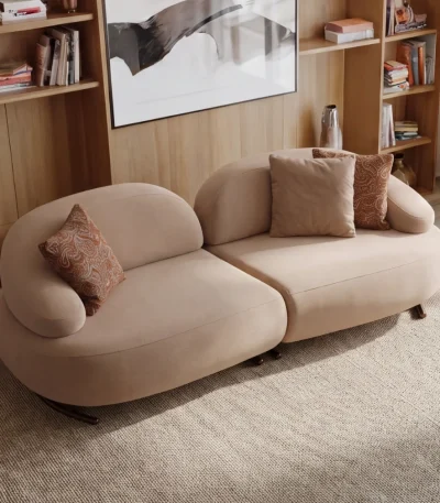 Tolia Sofa modern light beige two-module sofa featuring soft organic contours and plush seating arranged on a round rug.