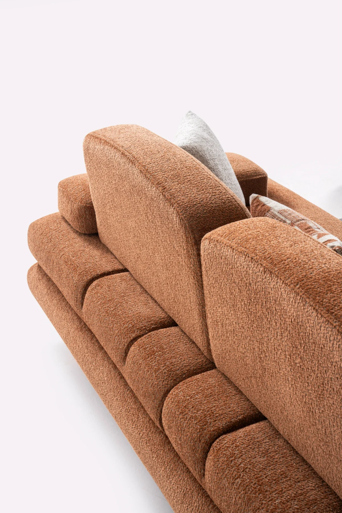 Modern living room featuring the Troyas sofa set in a warm terracotta hue, showcasing soft curves and a textured finish for a cozy, contemporary aesthetic – SofaTurkey.