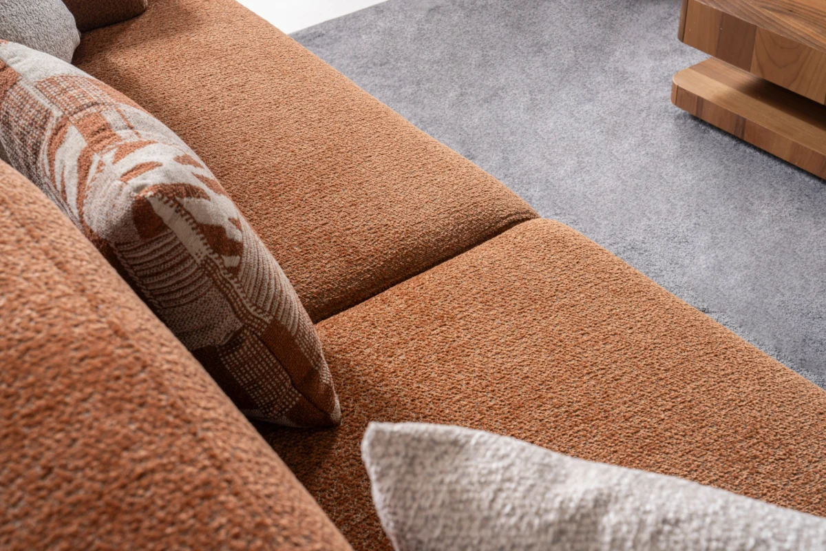 Modern living room featuring the Troyas sofa set in a warm terracotta hue, showcasing soft curves and a textured finish for a cozy, contemporary aesthetic – SofaTurkey.