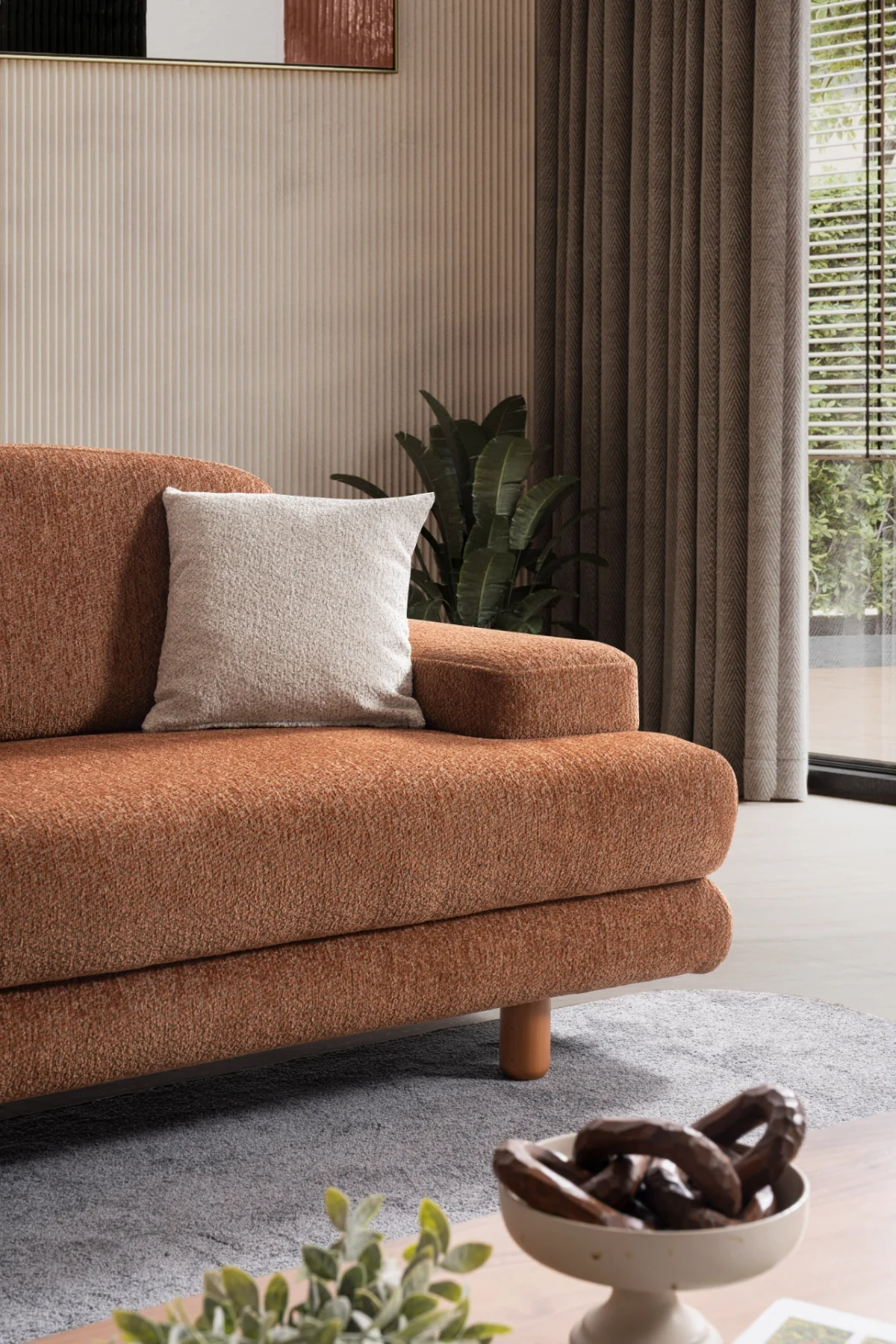Modern living room featuring the Troyas sofa set in a warm terracotta hue, showcasing soft curves and a textured finish for a cozy, contemporary aesthetic – SofaTurkey.
