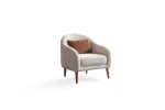 Troyas modern accent armchair with a curved backrest and textured ivory fabric, featuring an elegant sculptural design for a cozy living room corner – SofaTurkey.