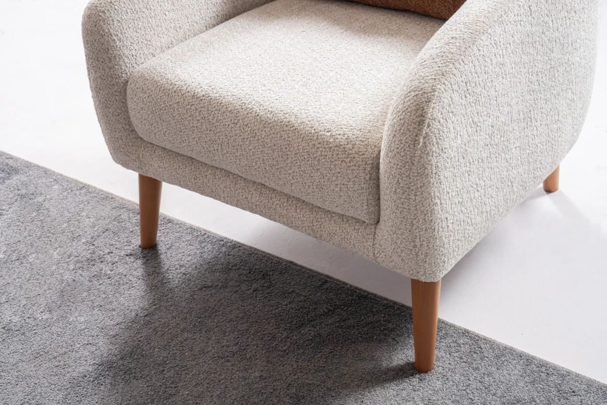 Troyas modern accent armchair with a curved backrest and textured ivory fabric, featuring an elegant sculptural design for a cozy living room corner – SofaTurkey.