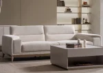 Velora Sofa modern cream living room couch featuring plush channel-tufted back cushions and integrated adjustment mechanism.