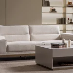 Velora Sofa modern cream living room couch featuring plush channel-tufted back cushions and integrated adjustment mechanism.