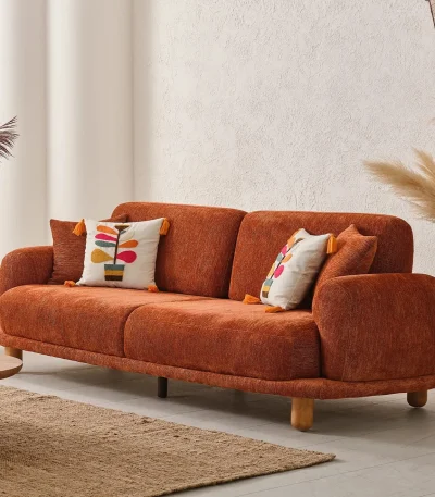 A vibrant Vira Sofa Set placed in a bright, minimalist room with organic shapes, designed to evoke a sense of warmth, creativity, and modern comfort.