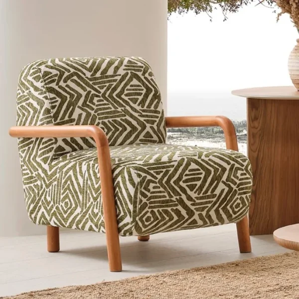 A vibrant Vira Armchair placed in a bright, minimalist room with organic shapes, designed to evoke a sense of warmth, creativity, and modern comfort.