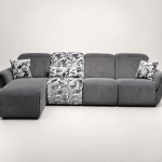 A modern sectional power recliner sofa featuring an integrated chaise lounge, patterned accent backrest and seat section, soft throw cushions, and smooth high-back plush cushioning set against a clean backdrop.