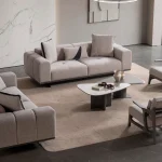 A modern Nova Sofa Set including two deep-seated plush sofas and two architectural wooden-frame accent armchairs arranged in a contemporary open-plan interior.