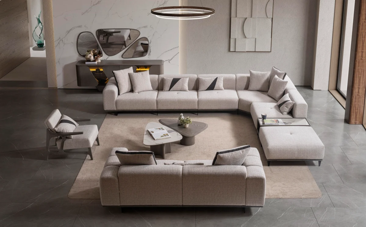 A modern living room sofa set including two deep-seated plush sofas and two architectural wooden-frame accent armchairs arranged in a contemporary open-plan interior.