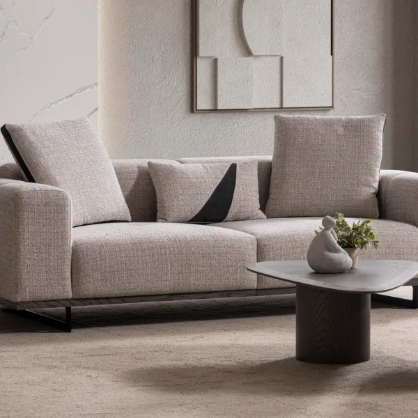 A modern textured fabric Nova Sofa featuring deep seating cushions, adjustable plush backrest pillows, channel-tufted wide armrests, and sleek low-profile metal legs in a minimalist room interior.
