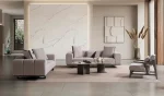 A modern textured fabric sofa featuring deep seating cushions, adjustable plush backrest pillows, channel-tufted wide armrests, and sleek low-profile metal legs in a minimalist room interior.