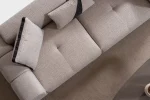 A modern textured fabric sofa featuring deep seating cushions, adjustable plush backrest pillows, channel-tufted wide armrests, and sleek low-profile metal legs in a minimalist room interior.