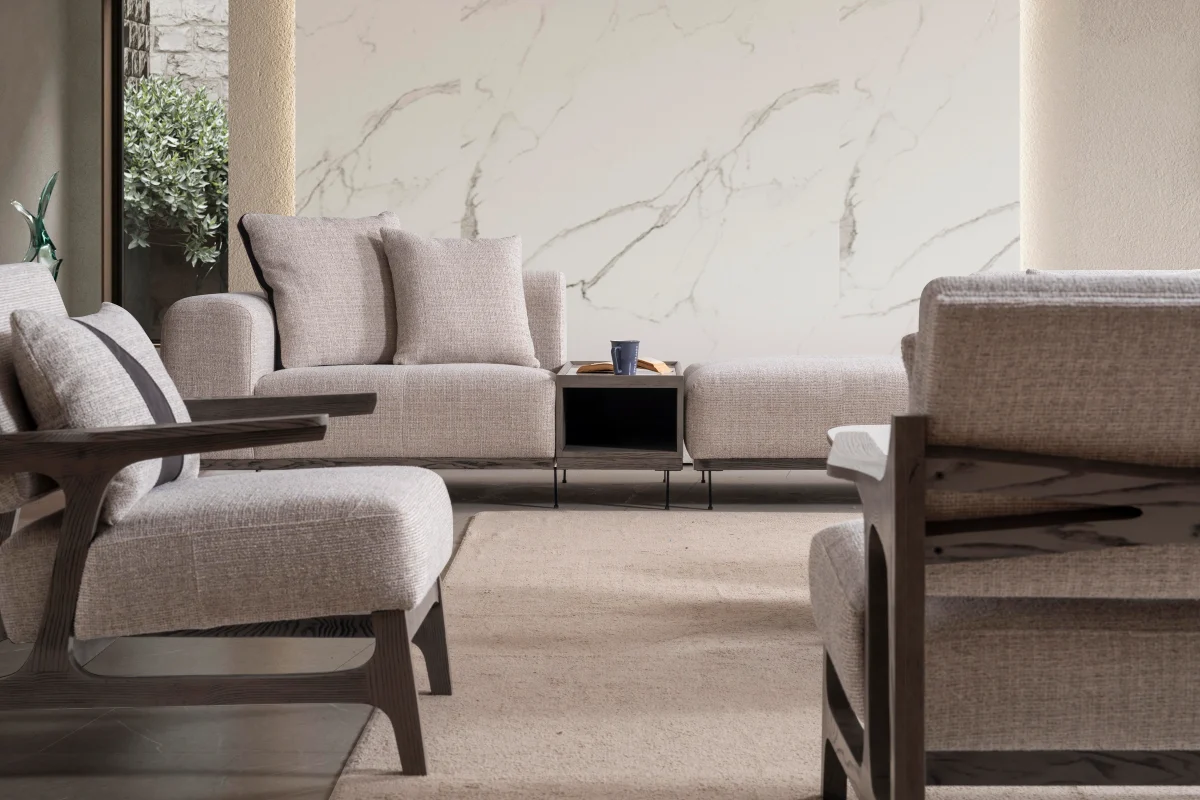 An extra-large U-shaped modular sectional sofa featuring expansive seating, plush backrest cushions, geometric accent pillows, and integrated tray console modules in a luxurious modern interior.