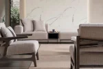 An extra-large U-shaped modular sectional sofa featuring expansive seating, plush backrest cushions, geometric accent pillows, and integrated tray console modules in a luxurious modern interior.
